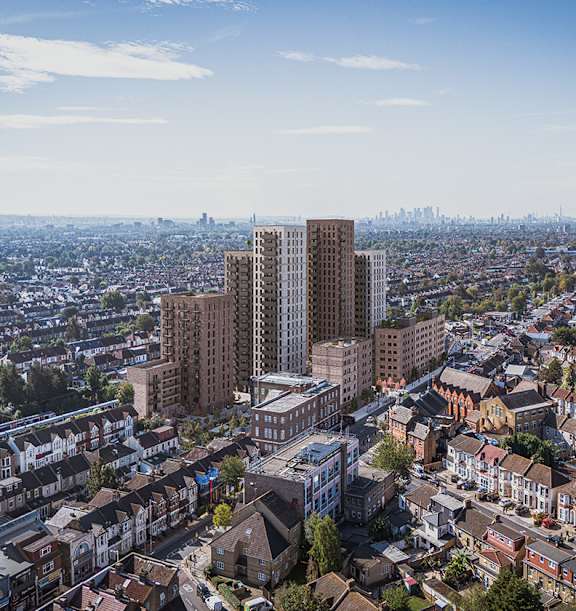 A cityscape with a mix of residential and commercial buildings under a clear sky.