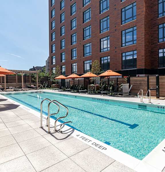 A pool with a white and blue border and a white and black border with the words