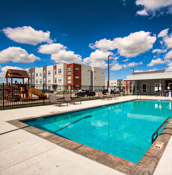 A large swimming pool in a sunny outdoor setting.