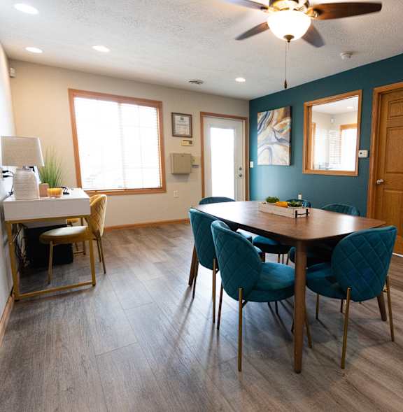 A kitchen with a table and chairs in the middle of the room.