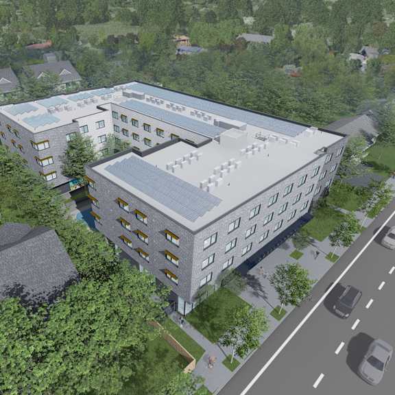 an aerial view of a large white building next to a street