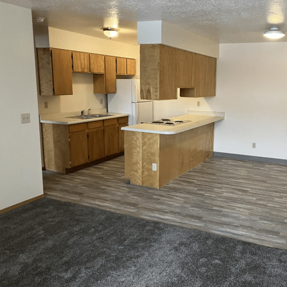 an empty kitchen with an island in the middle of it