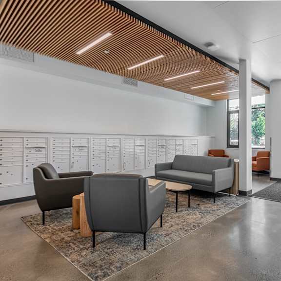 a waiting area with a couch, chairs, and a coffee table.