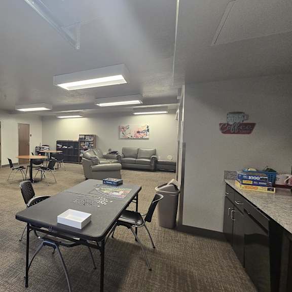a room with a table and chairs in it.