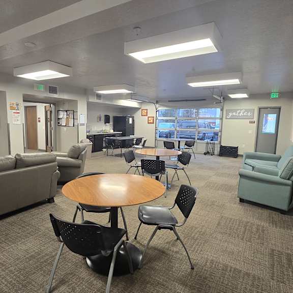 a conference room with a couch, chairs, and a table.