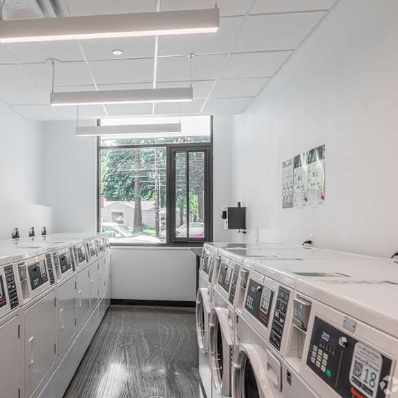 a row of washing machines in a laundromat.