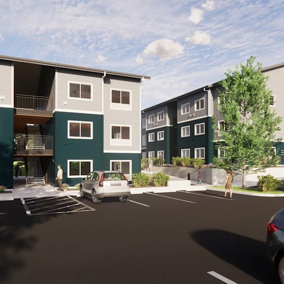 a modern apartment complex with a parking lot in front.