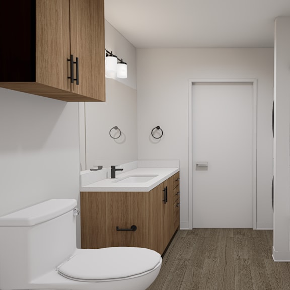 a white toilet sits in a bathroom with a white tub and a white sink.