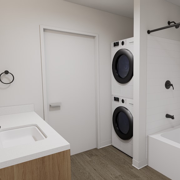 a white bathroom with a washing machine built into the wall.