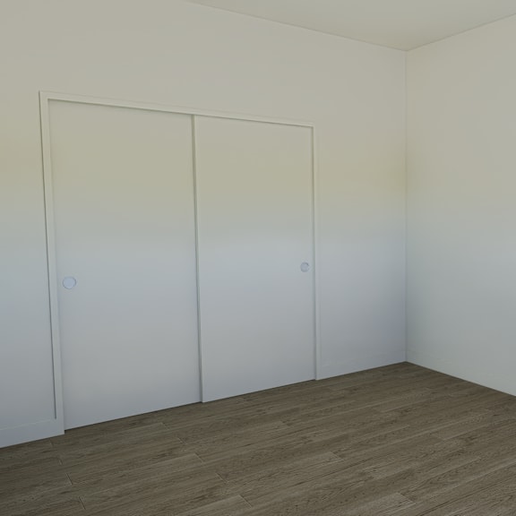 a room with a brown floor and three white doors.