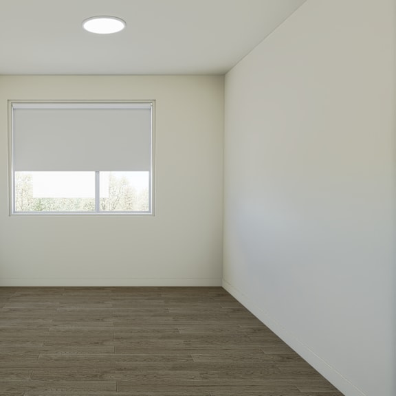 a room with a window and a carpeted floor.