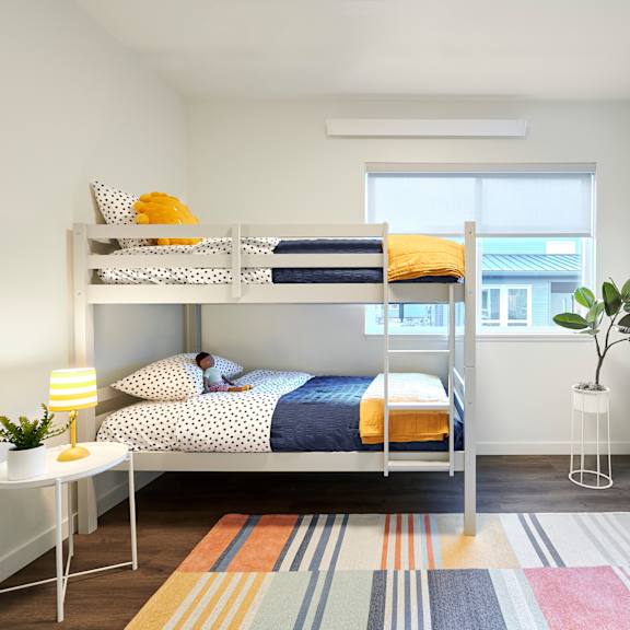 a bedroom with a bunk bed and a window