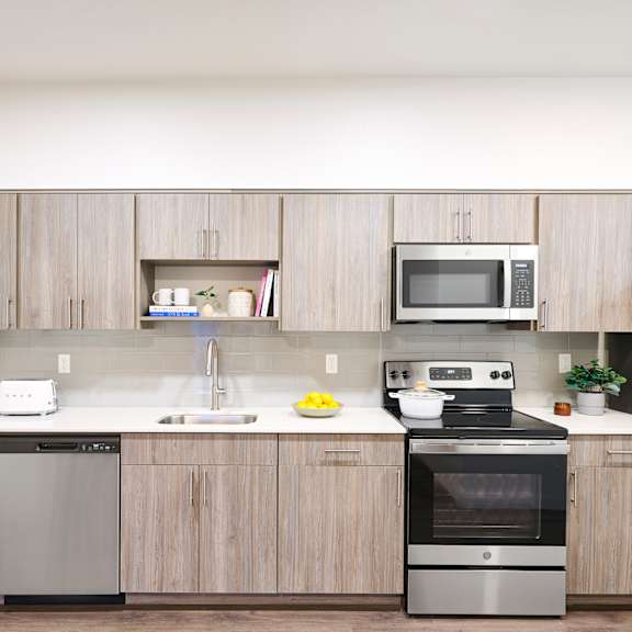 a kitchen with wooden cabinets and stainless steel appliances
