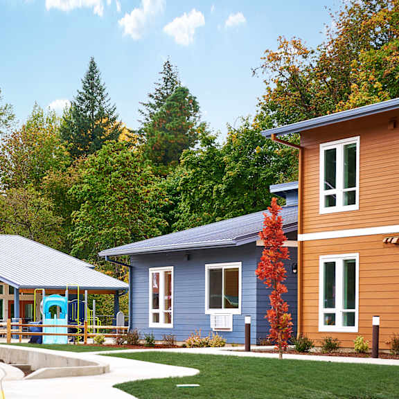 a row of houses with trees in the background