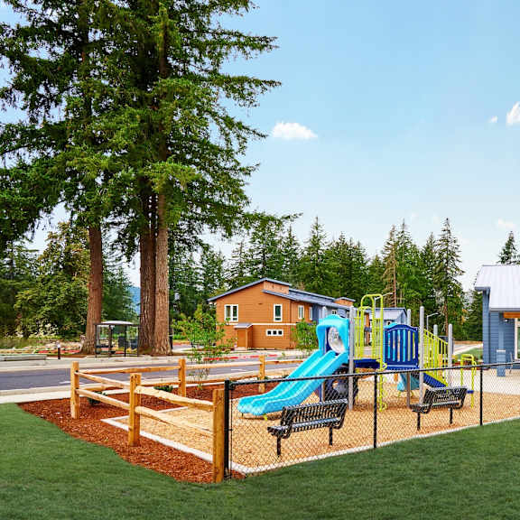 a playground with a swing set and a pavilion