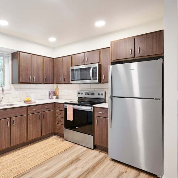 a kitchen with stainless steel appliances and wooden cabinets
