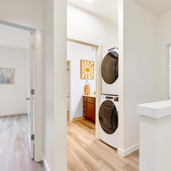 a living room with a washer and dryer in it