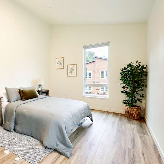 a bedroom with a bed and a window