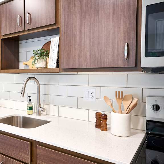 a clean kitchen with wooden cabinets and a sink