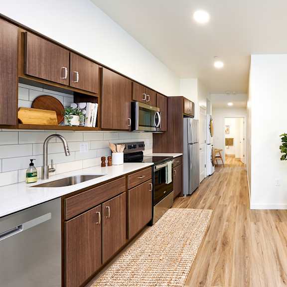 a kitchen with wooden cabinets and stainless steel appliances