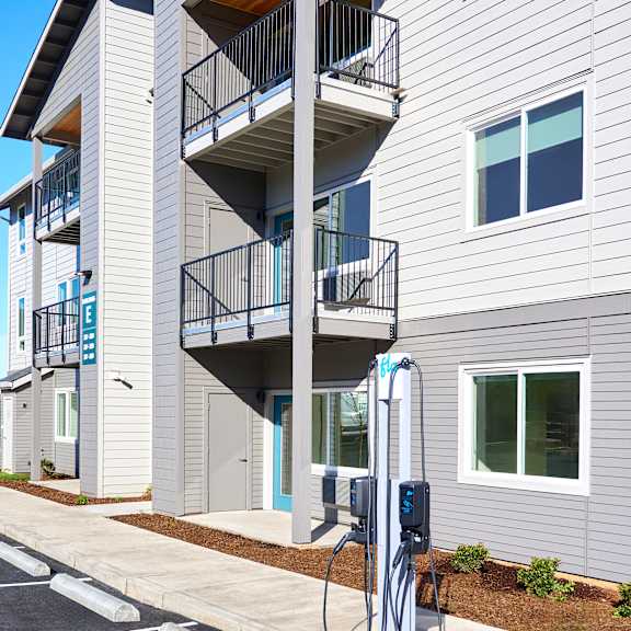 a gas pump in front of an apartment building
