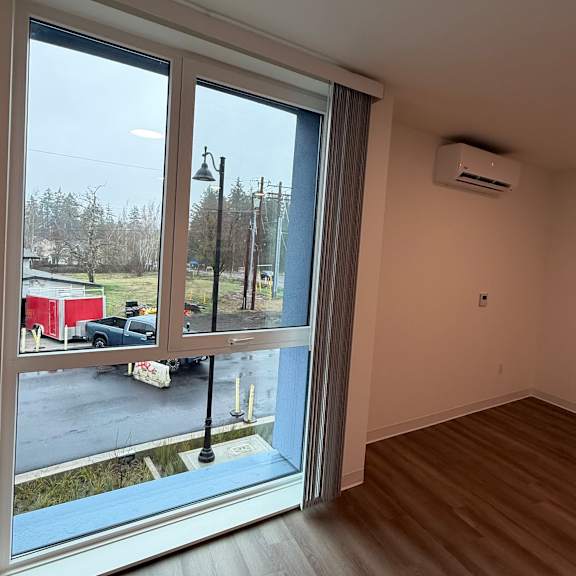 a room with a large window overlooking a parking lot.