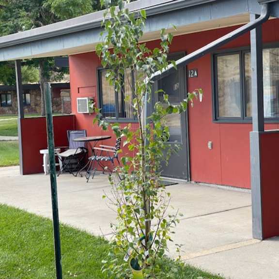 a red building with a white door and windows.