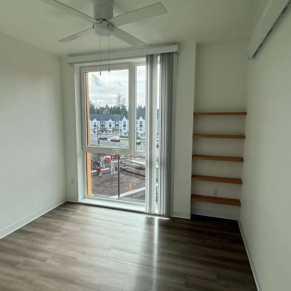 a room with a sliding glass door leading to a balcony.