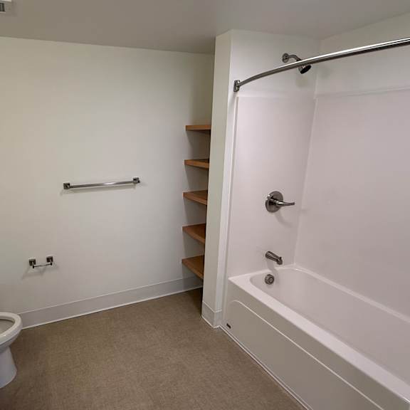 a white bathroom with a sink, toilet, and bathtub.