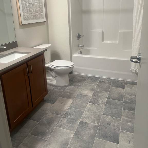 a small bathroom with a toilet and a bath tub
