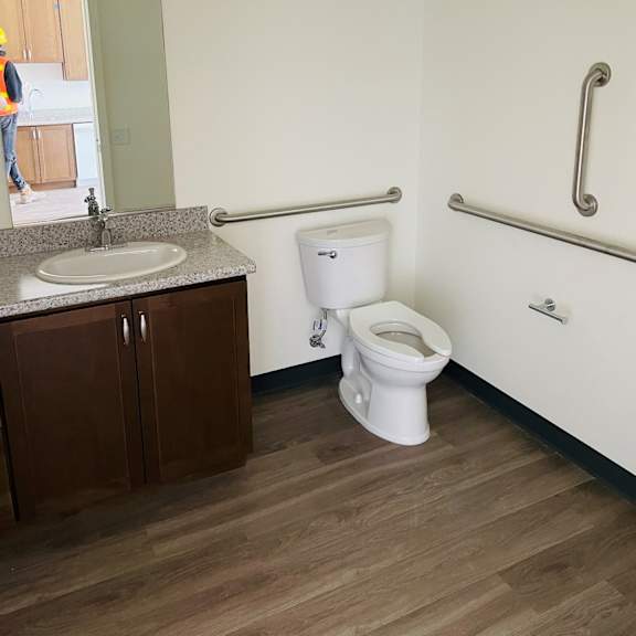 a bathroom with a toilet sink and mirror