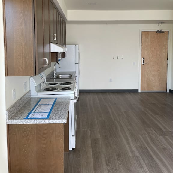 a kitchen and living room in a 555 waverly unit