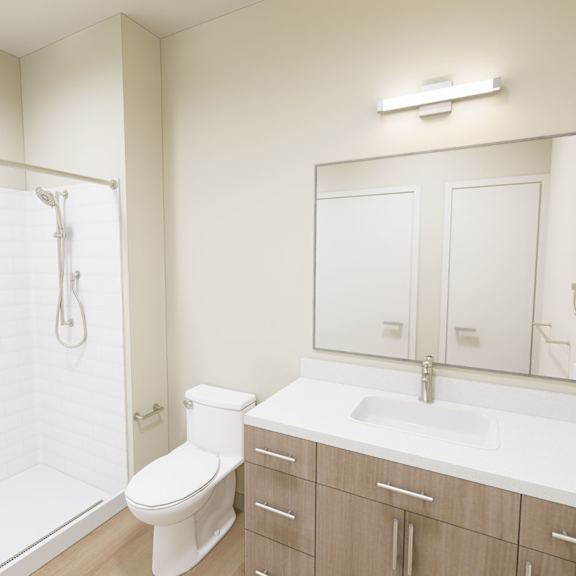 a white bathroom with a toilet, sink, and mirror.