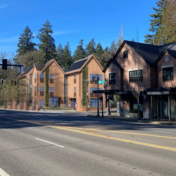 a street view of a row of houses with a traffic light in the background.