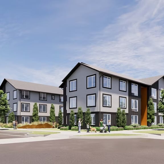 a modern apartment complex with a parking lot in front.