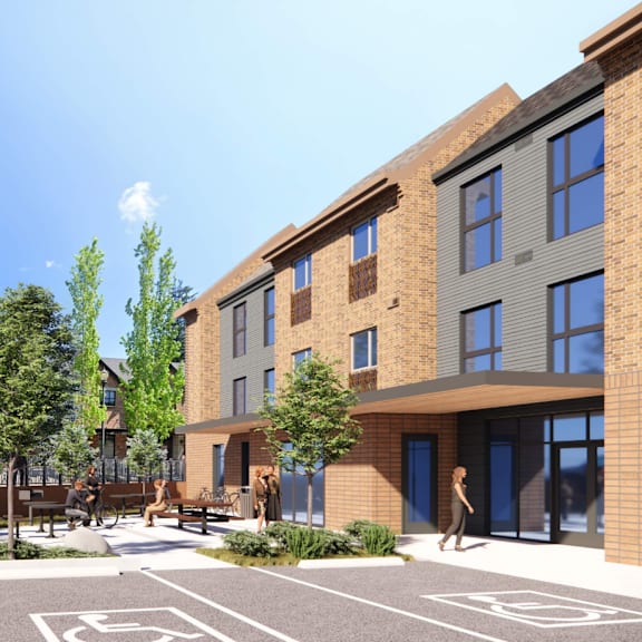 a modern building with a parking lot in front.