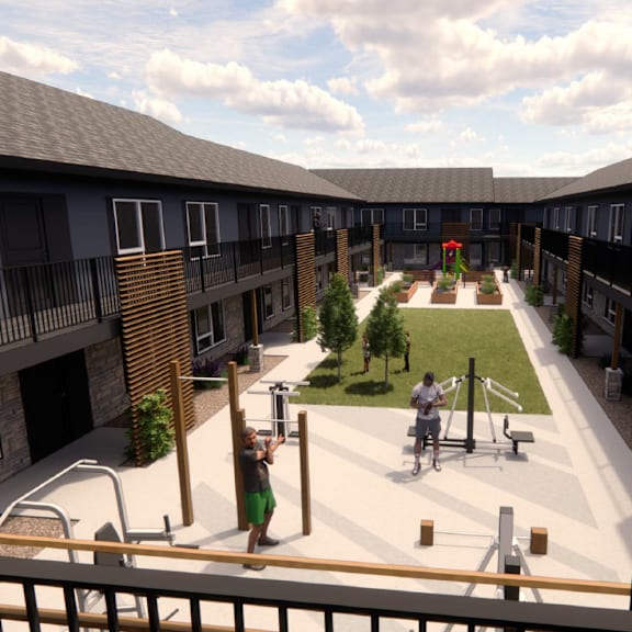 a courtyard with a playground and a woman walking a dog.