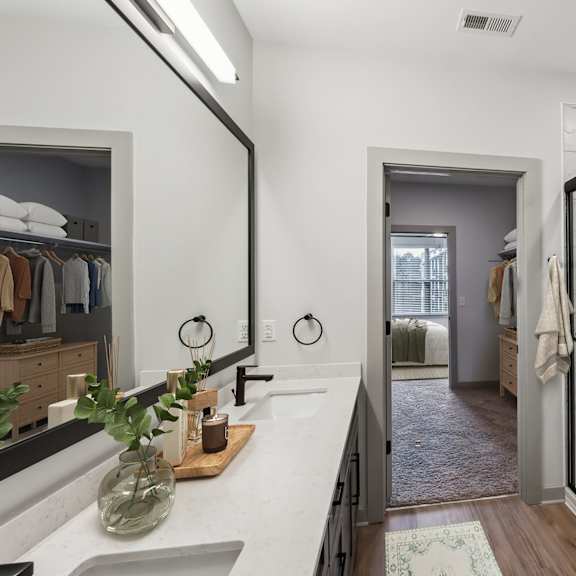 Thumbnail 11 of 21 A bathroom with a marble countertop and a walk-in shower.