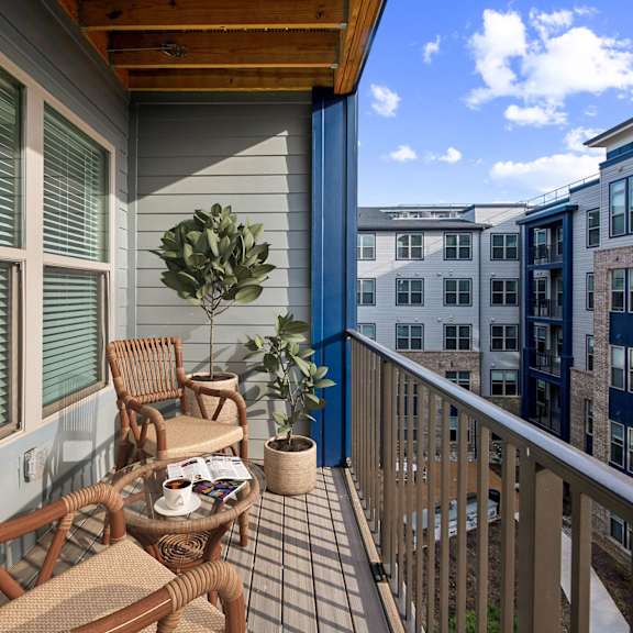 Thumbnail 5 of 10 A balcony with a table and chairs.