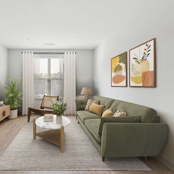Thumbnail 6 of 21 A living room with a green couch, a wooden table, and a flat screen TV mounted on the wall.