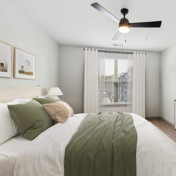 Thumbnail 9 of 21 A bedroom with a bed, dresser, and ceiling fan.