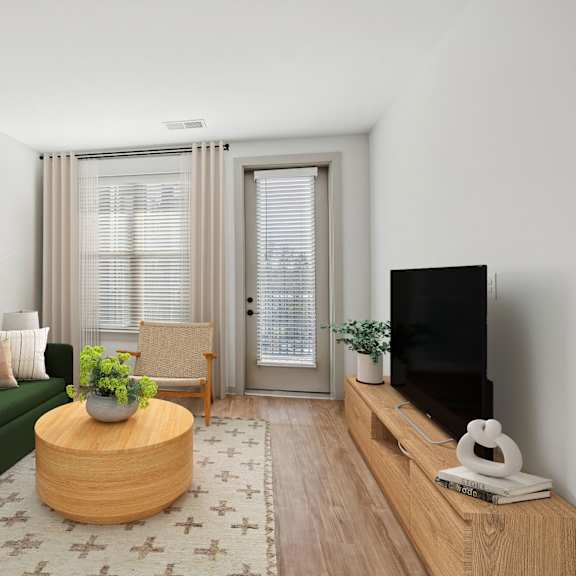 Thumbnail 4 of 10 A living room with a green couch, a wooden coffee table, and a flat screen TV.