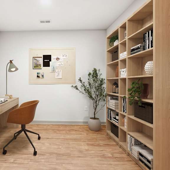 Thumbnail 6 of 10 A room with a desk, chair, and bookshelf.
