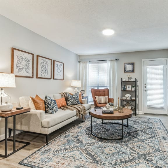 a living room with a fireplace and a couch  at Brampton Moors, Cary, NC
