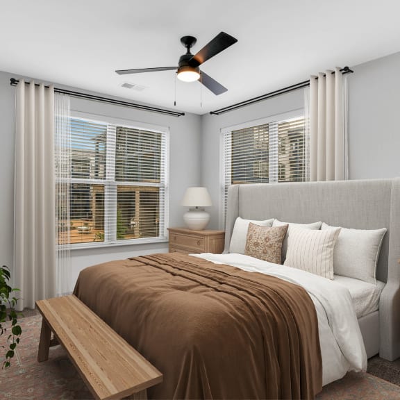 Thumbnail 7 of 11 a bedroom with a large bed and a ceiling fan