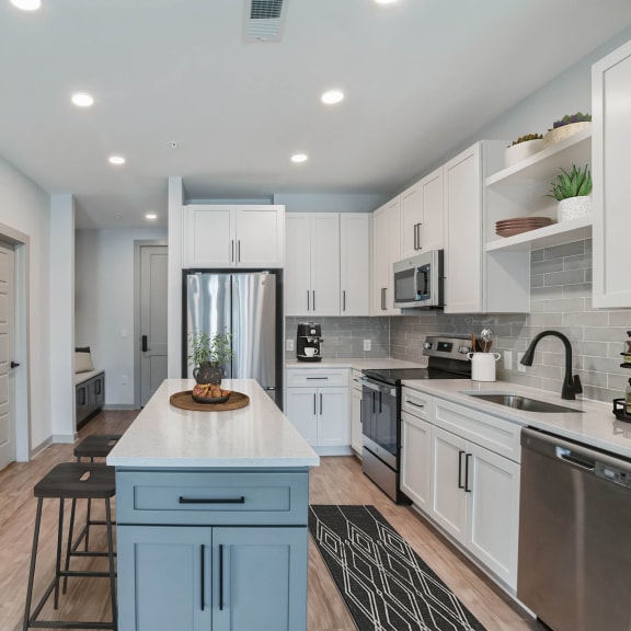 Thumbnail 3 of 11 a kitchen with white cabinets and a white counter top