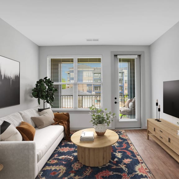 Thumbnail 5 of 11 a living room with a white couch and a television