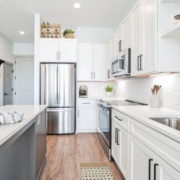 Thumbnail 2 of 6 a kitchen with stainless steel appliances and white cabinets  at Preston Ridge, Cary, NC