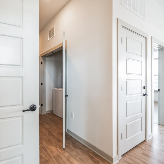 Thumbnail 8 of 21 a bedroom with white doors and a hallway to a closet at Preston Ridge, Cary