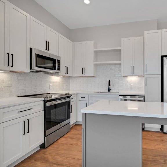 Thumbnail 7 of 21 a kitchen with white cabinets and stainless steel appliances at Preston Ridge, Cary, 27513